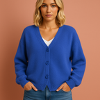 Women’s knitted cardigan in blue with V-neck and button design, soft and comfortable for casual and elegant outfits.