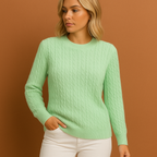 Women’s knitted sweater in green with classic cable design, soft and comfortable for casual and elegant winter outfits.