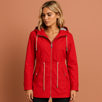 Women’s long waterproof raincoat in red with hood, breathable and stylish for rainy days.