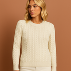 Women’s knitted sweater in white with classic cable design, soft and comfortable for casual and elegant winter outfits.