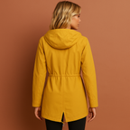 Women’s long waterproof raincoat in yellow with hood, breathable and stylish for rainy days.