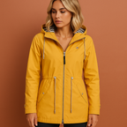 Women’s long waterproof raincoat in yellow with hood, breathable and stylish for rainy days.